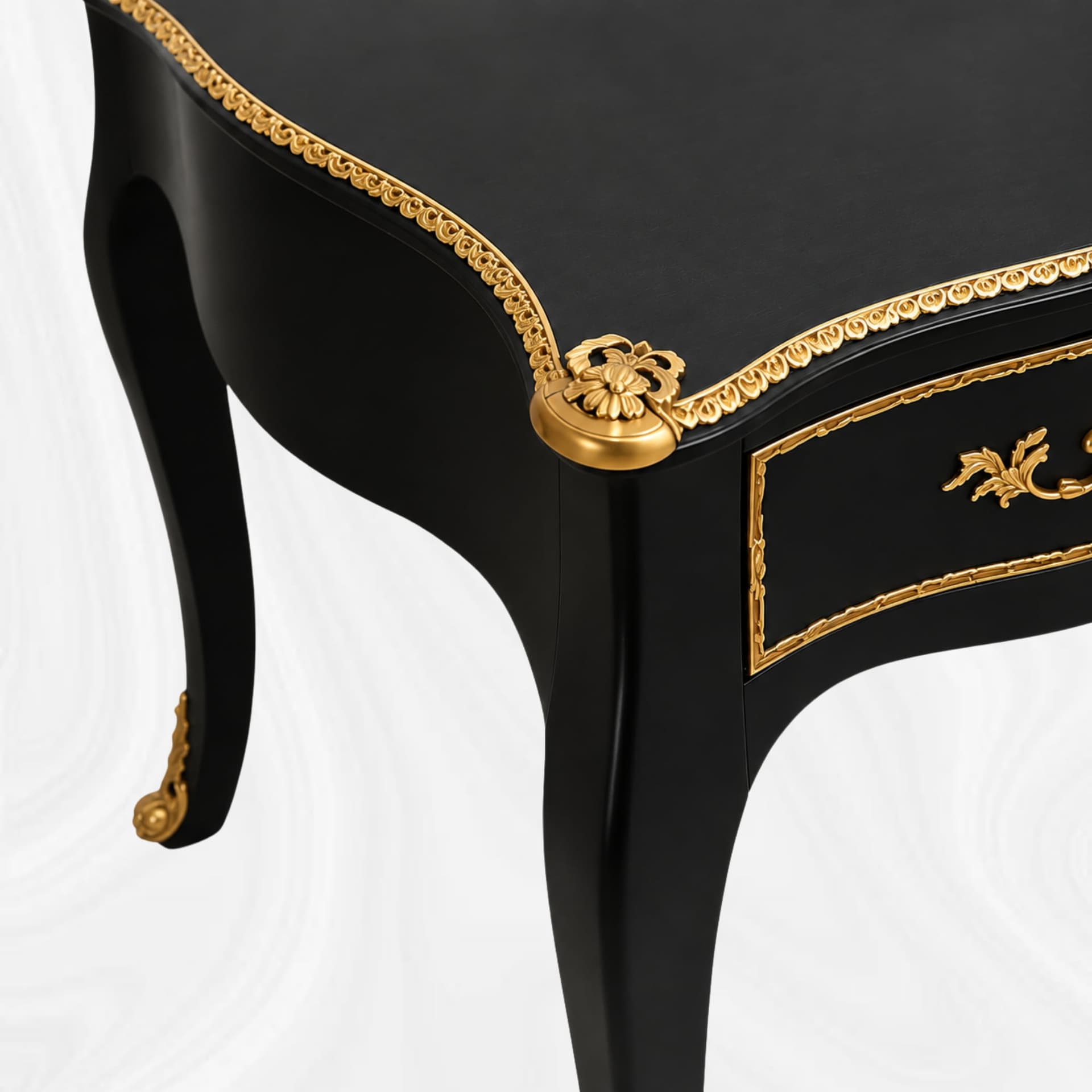 Corner detail of the top, gilt-coloured decoration and leg